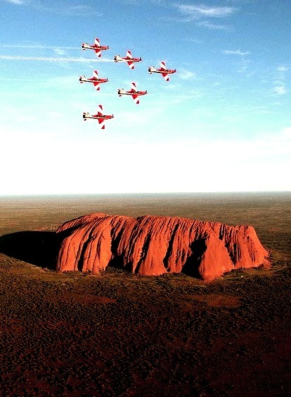 The Roulettes fly in wedge formation over Ayers Rock, Australia